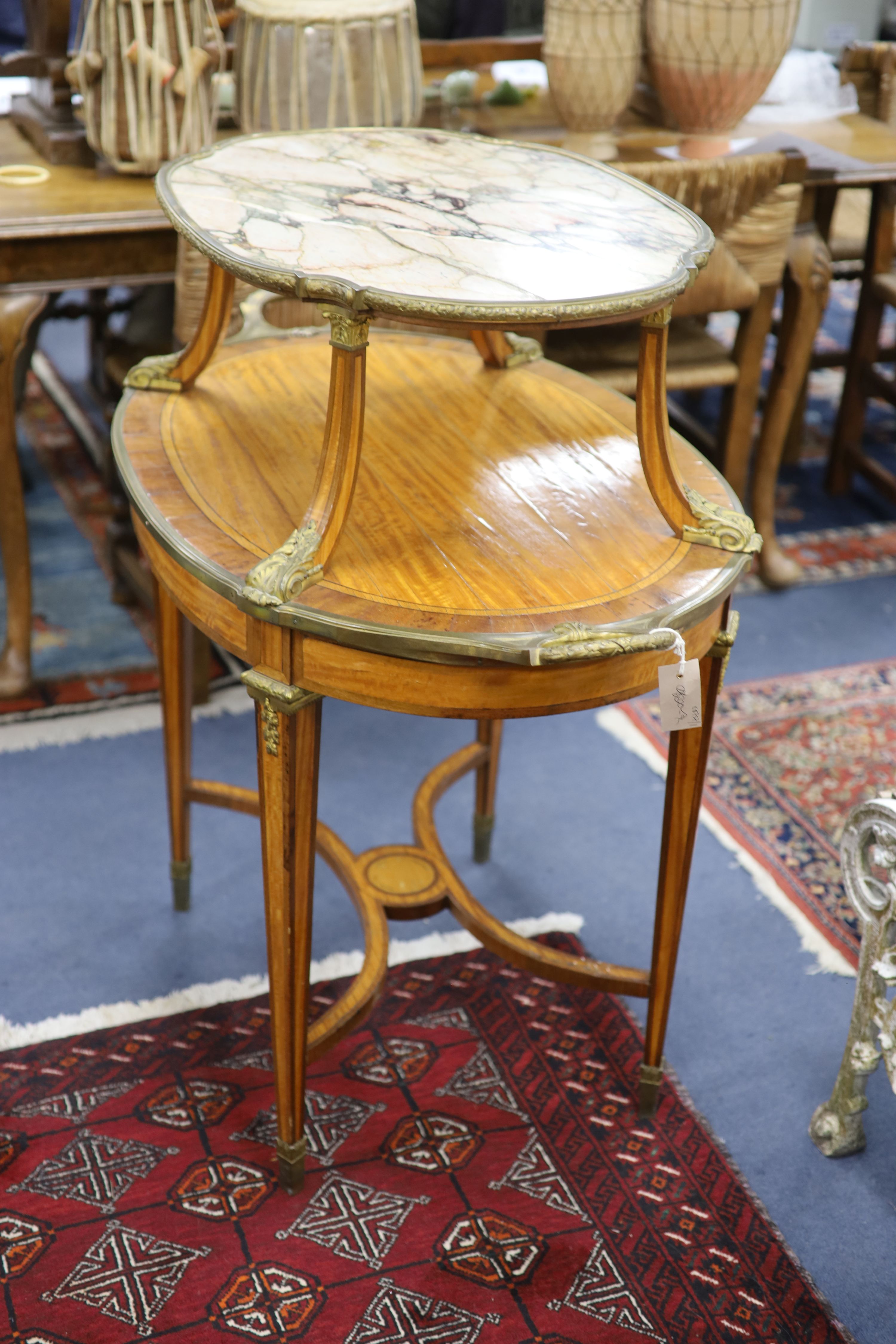 A late 19th century French satinwood, rosewood crossbanded and gilt metal mounted two tier oval etagere,